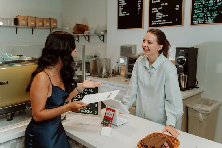 Two women talking at the counter