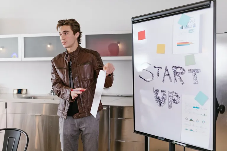 Man presenting in front of a board