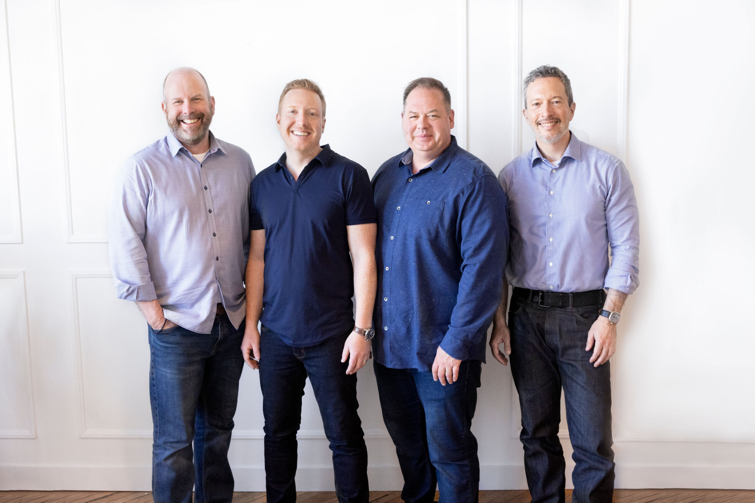 0K1A0828-1 picture of the four founders of Dig Insights. They are four white males standing against a white background, smiling at the camera.
