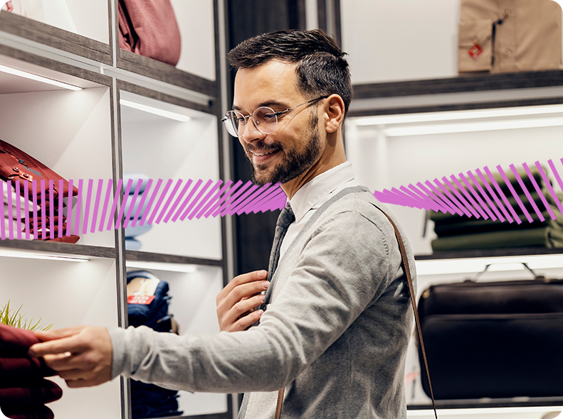 Man shopping for clothes, making decisions